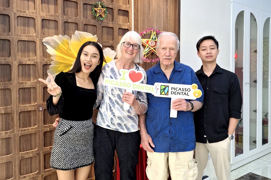 International patient and family with Picasso Dental staff at the Hanoi clinic