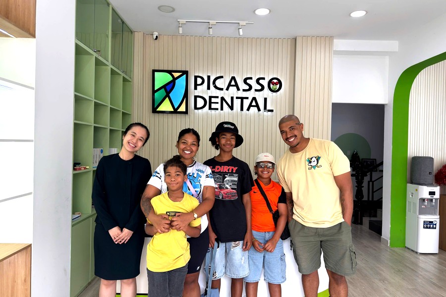 International family at the Picasso Dental Hanoi reception lobby